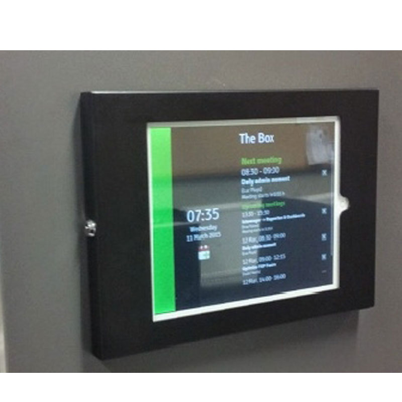 An ipad is displayed on a wall.