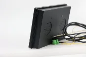 A GK-TW7A-3268-FWM 7-inch Android 11 PoE in-wall flush mount or embedded Panel PC HMI with RS232/485 interface with two wires attached to it.