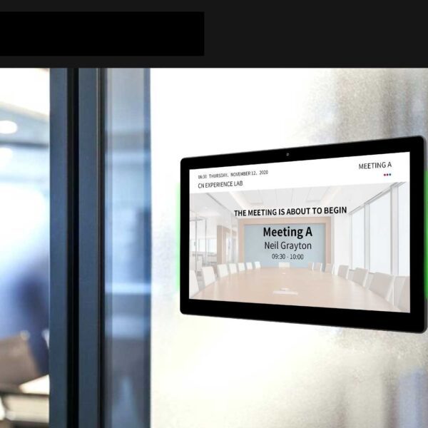 A GK-1052PL-MR 10" Android POE Wall Mount Meeting Room Display w LED status bar (Optional Meeting Room App) is displayed on a wall in a conference room.