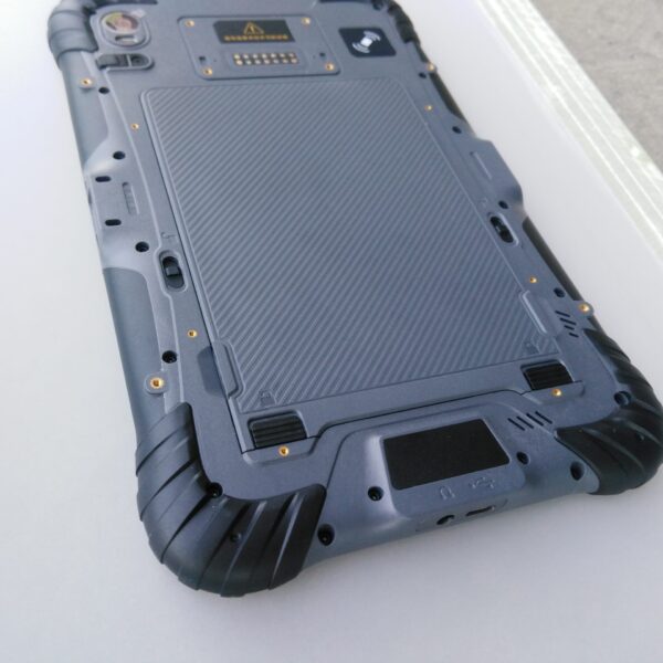 The back of a GK-ST8-QC 8" Android Rugged Tablet with 1D/2D Barcode scanner on a table.